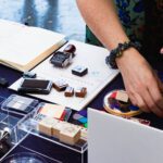 Person using an Artline stamp on office paperwork at a desk, showcasing professional stationery.