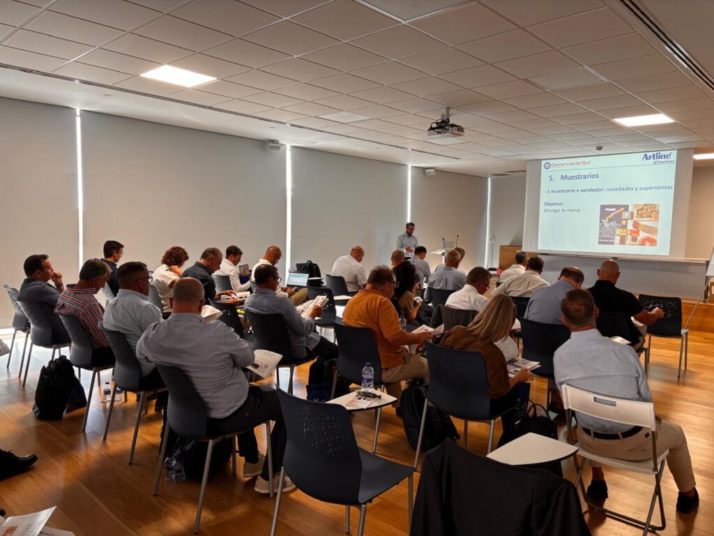 A sales meeting with a bunch of people watching a presetation